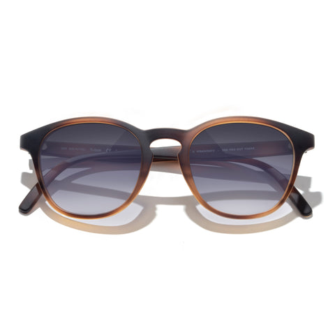 Sunglasses with brown frame and dark lenses on a white background