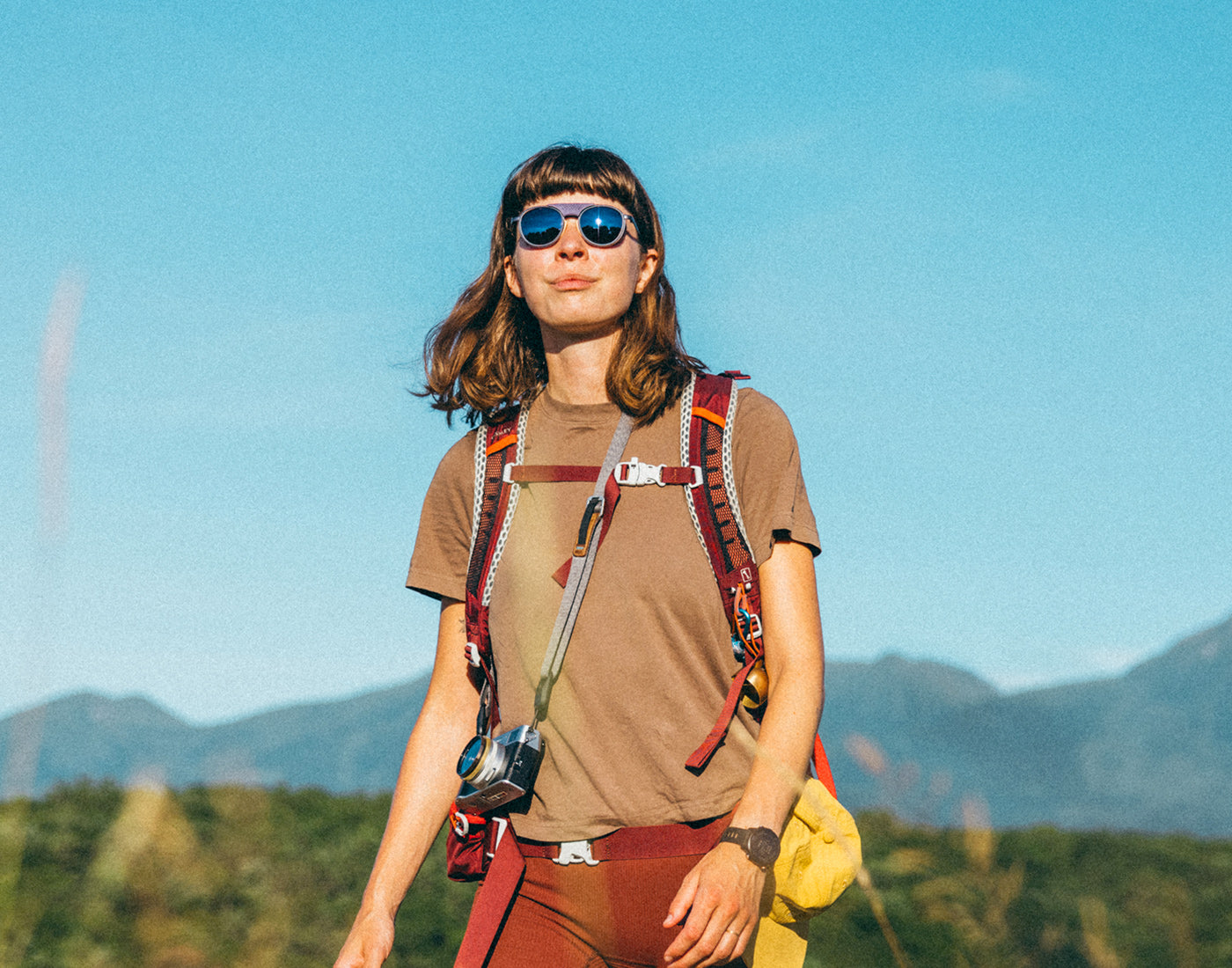 woman hiking in sunski strada violet galaxy