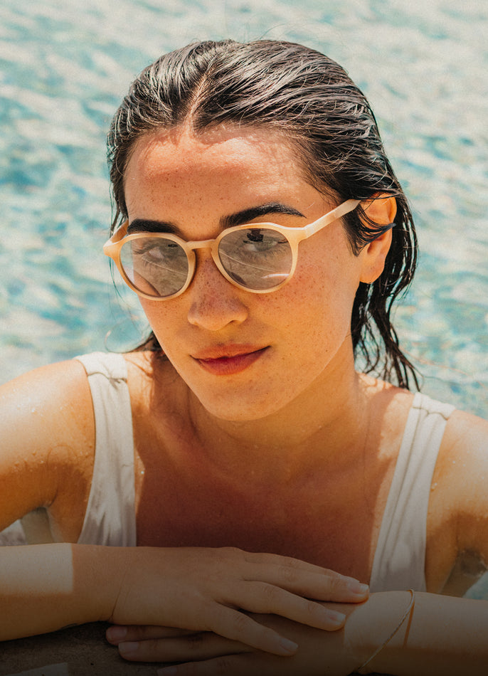 Woman wearing sunglasses by a pool