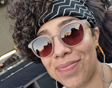 Person wearing sunglasses and a headband with a blurred background