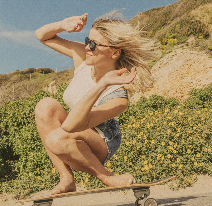 woman wearing sunski sunglasses while skateboarding