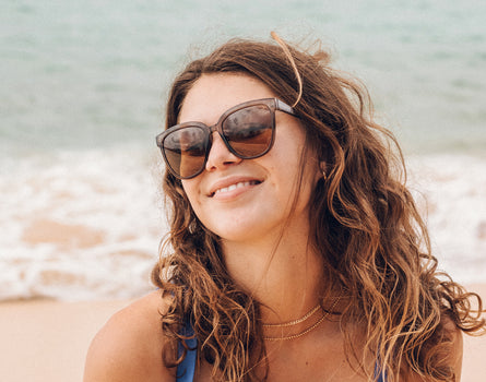 sunski camina cola amber girl smiling at the beach