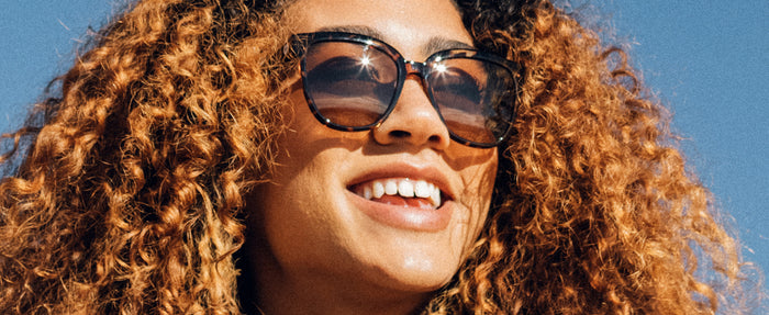 girl smiling wearing sunski camina sunglasses