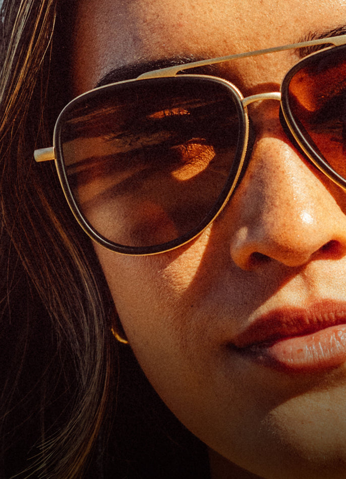 Close-up of a person wearing sunglasses with a blurred background