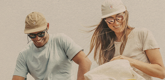 man and woman laughing wearing sunski hats