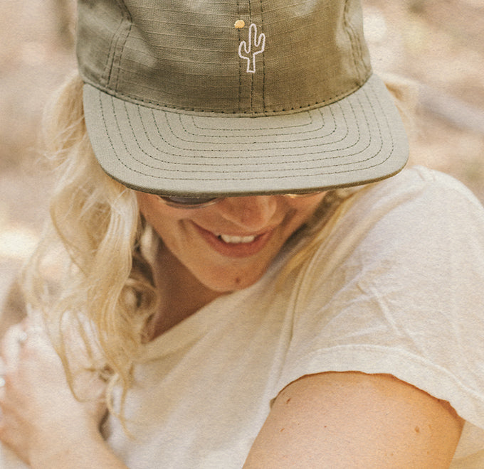 girl looking down wearing hat