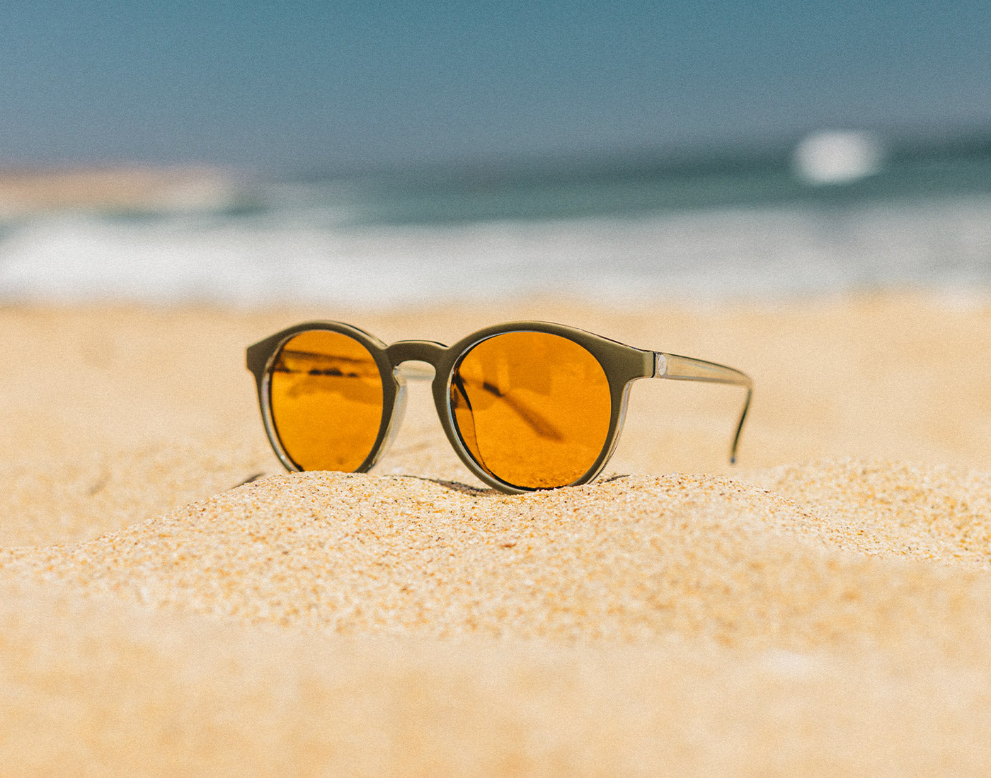 dipsea sunglasses on the sand at the beach