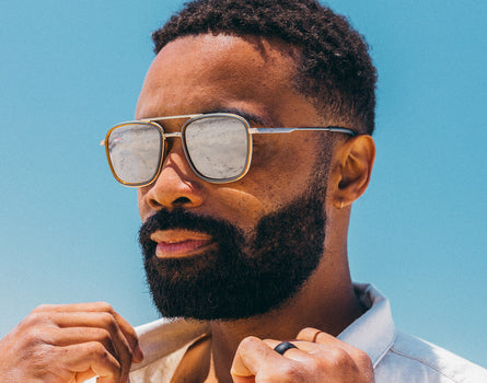 guy wearing estero sunglasses blue sky