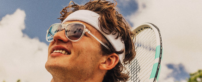guy with a tennis racket wearing sunski foxtrot sunglasses