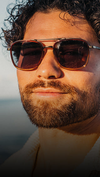 Man wearing sunglasses with a blurred background