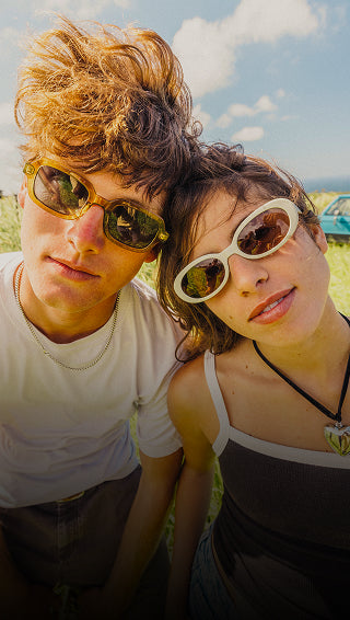 Two people wearing sunglasses with a scenic background