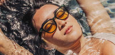 woman in sunski lo light sunglasses in the water