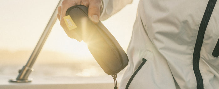 person holding sunski zipper case