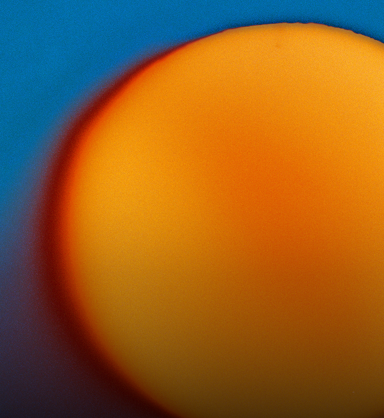 Close-up of a sun-like object with a blue background