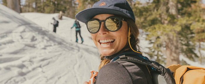 woman smiling wearing sunski polarized sunglasses with side shields