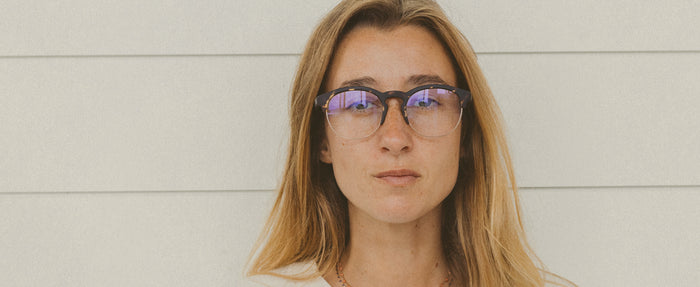 woman wearing sunski blue light glasses