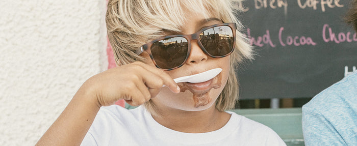kid eating ice cream wearing sunski kids' polarized sunglasses