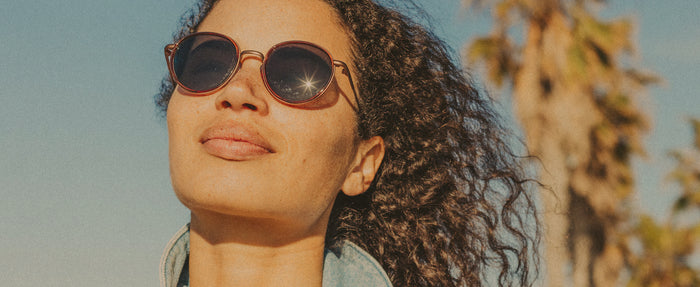 woman basking wearing sunski premium metal sunglasses