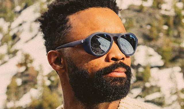 man in sunski sunglasses in the mountains