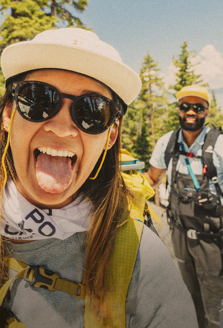 woman and man adventuring in the mountains in sunski sunglasses