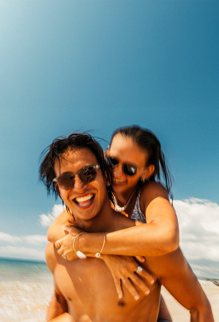 man and women in new sunski sunglasses at the beach