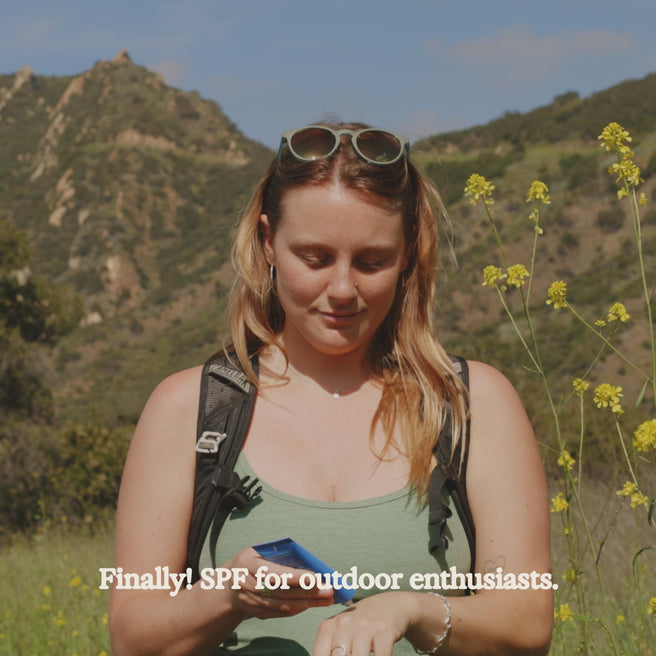 woman applying sol power sunscreen