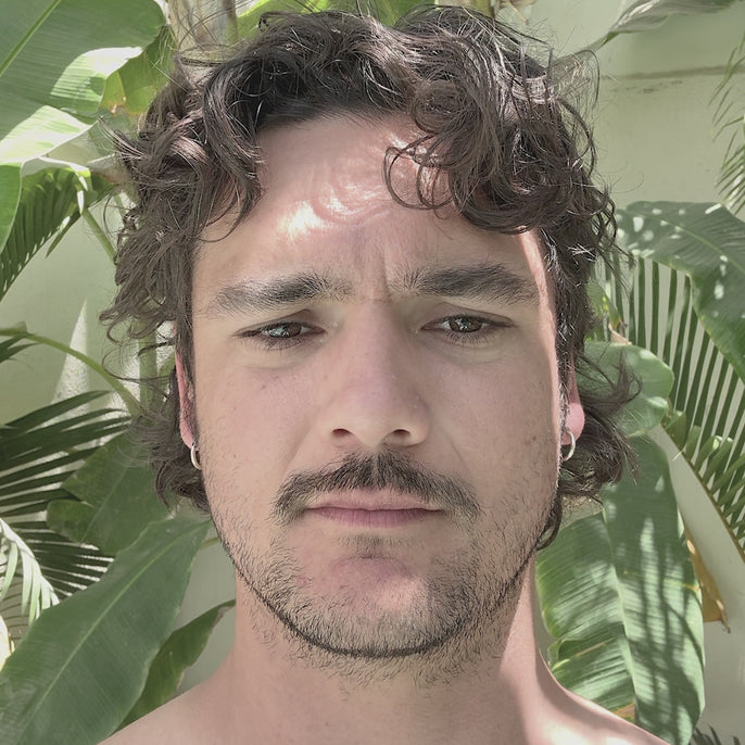 man trying on avila sunglasses