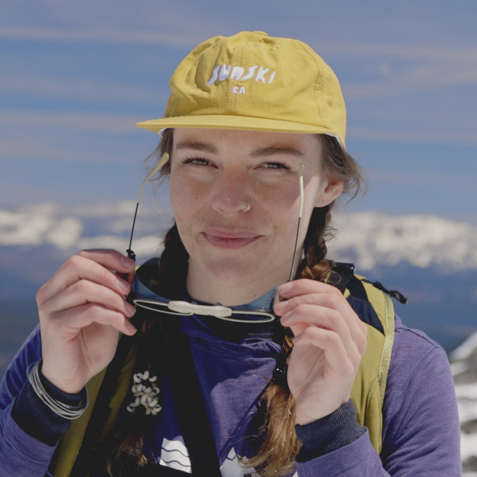 woman trying on strada sunglasses