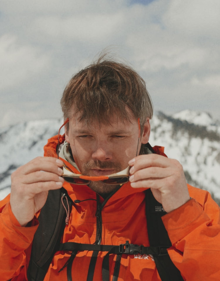 man wearing sunski ferrata sunglasses in the mountains