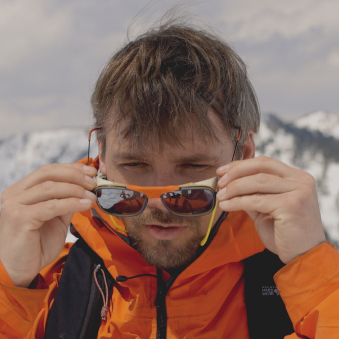 man trying on ferrata sunglasses