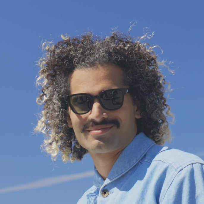 man trying on miho sunglasses