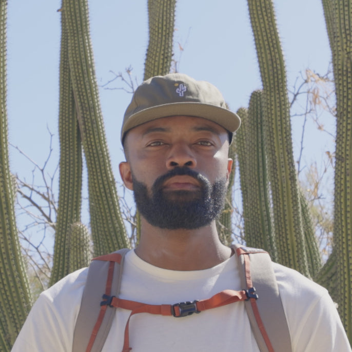 man trying on treeline sunglasses