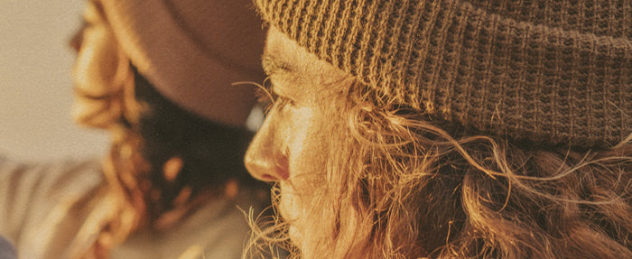 man and woman in winter sun beanies