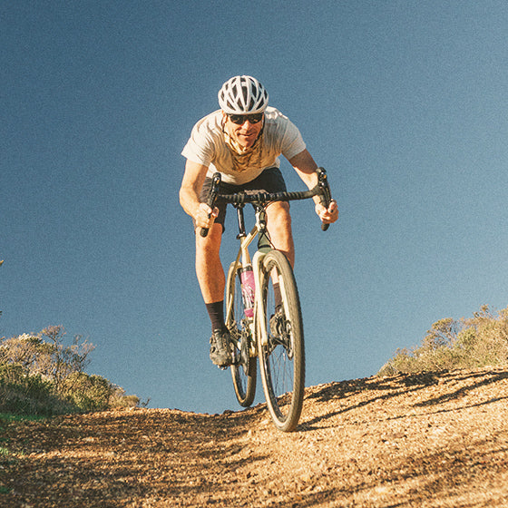 man riding bike wearing sunski polarized sunglasses