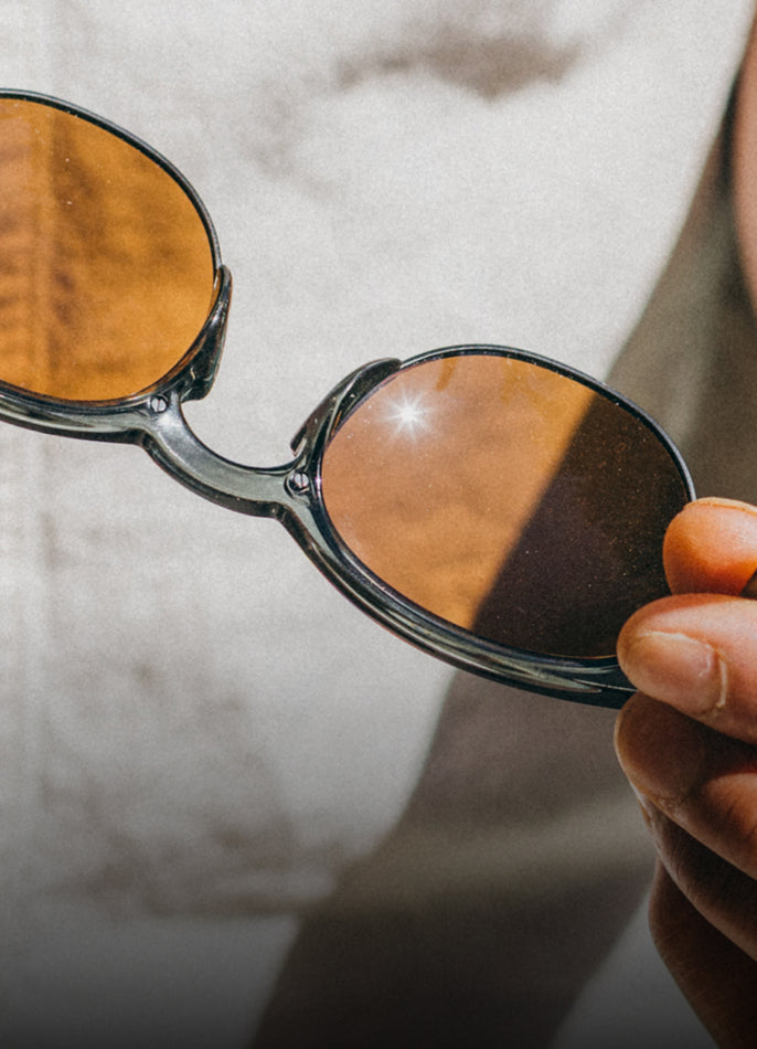 man holding avila sunski sunglasses