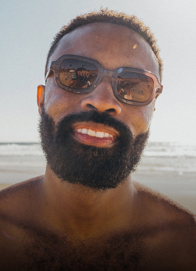 Man with sunglasses and beard on a beach