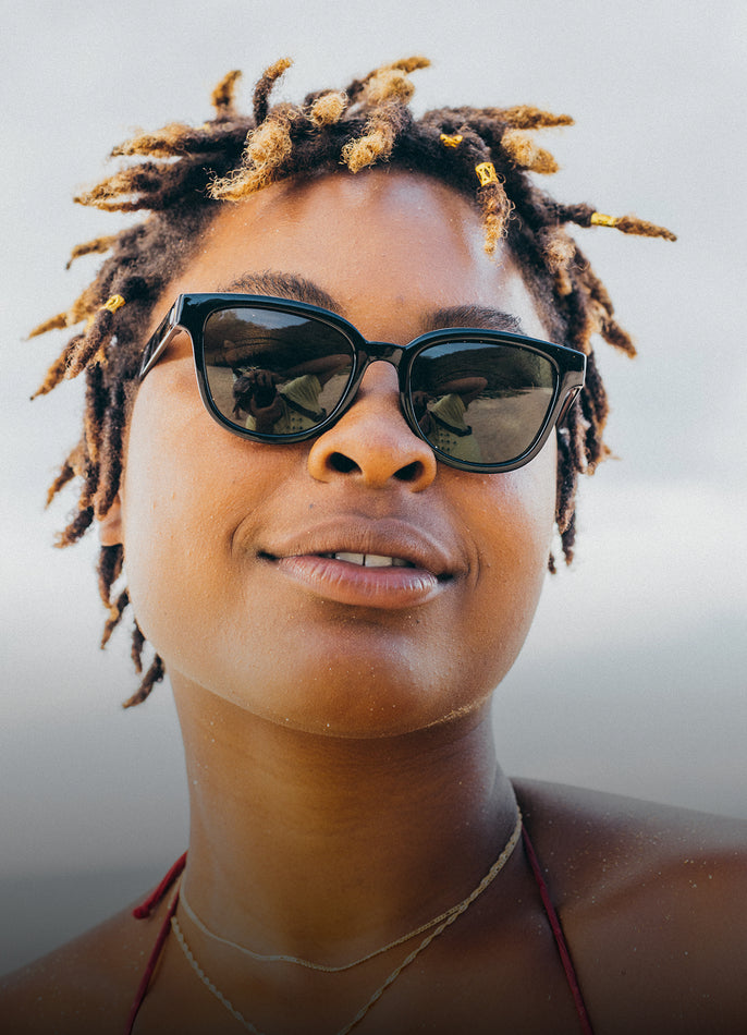 Person wearing sunglasses with a blurred background