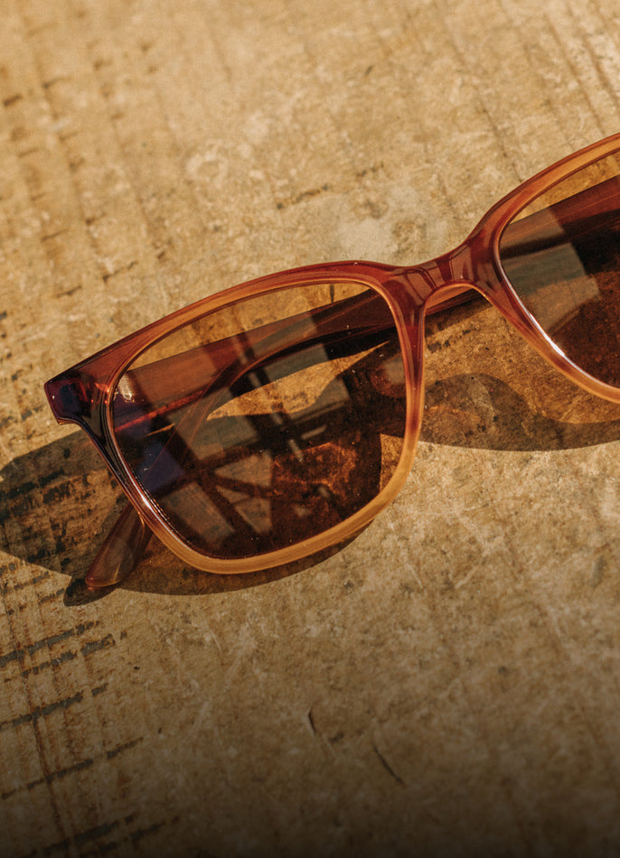 Brown sunglasses on a textured surface