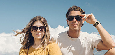 man and women wearing polarized sunglasses by sunski