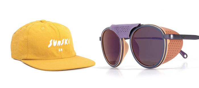 Yellow cap with 'Sunski' logo and round sunglasses with brown frame and purple lenses on a white background