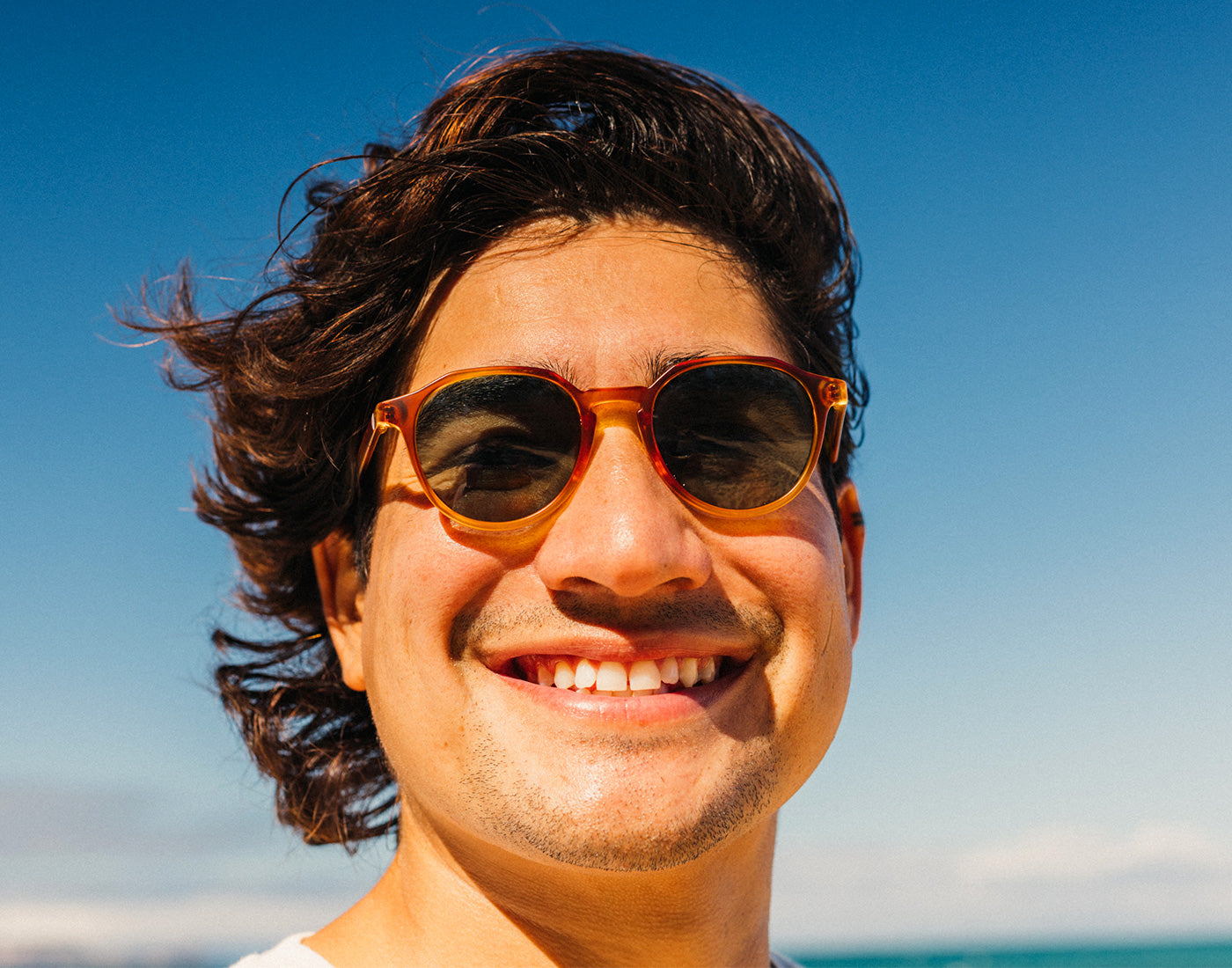 guy laughing wearing sunski vallarta sunglasses