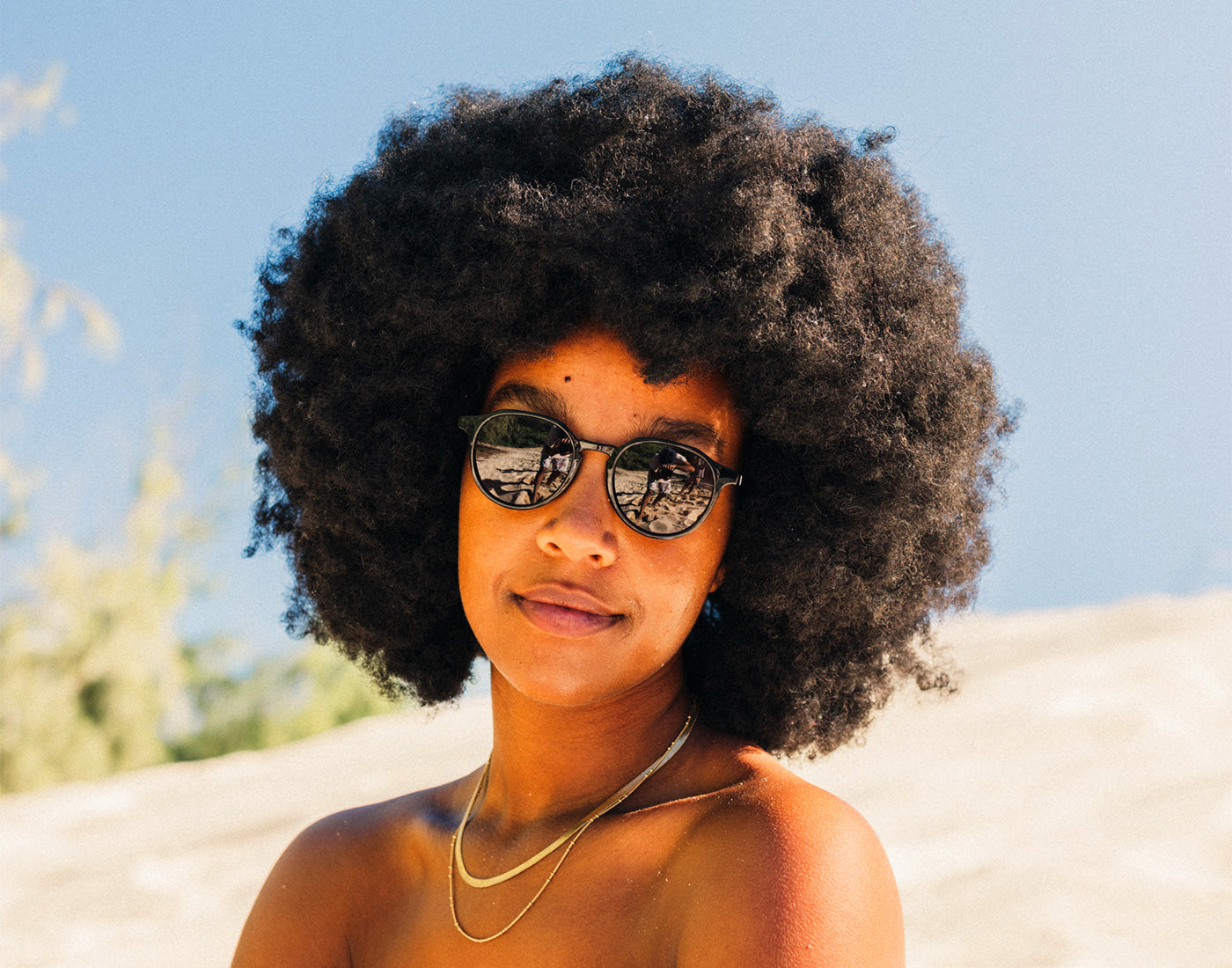 girl soft smiling wearing sunski vallarta sunglasses
