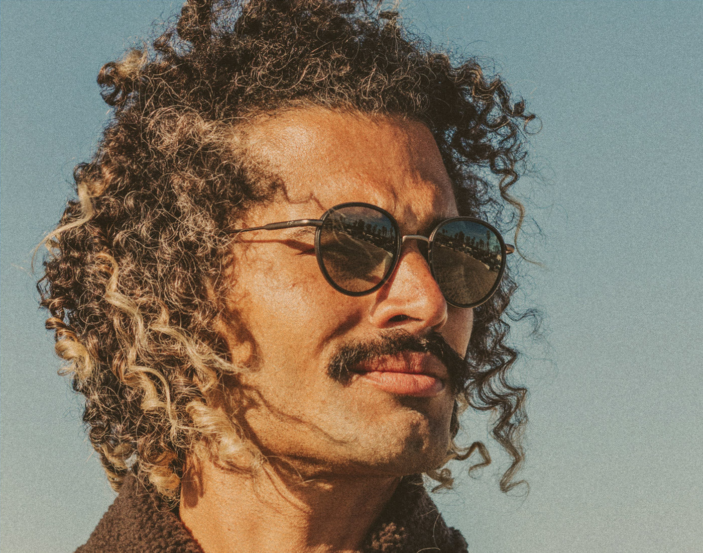 profile of man wearing sunski baia sunglasses