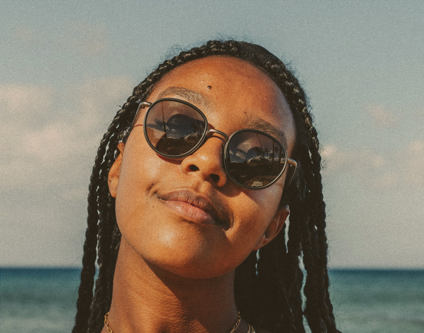 woman soaking in the sun wearing usnski baia sunglasses