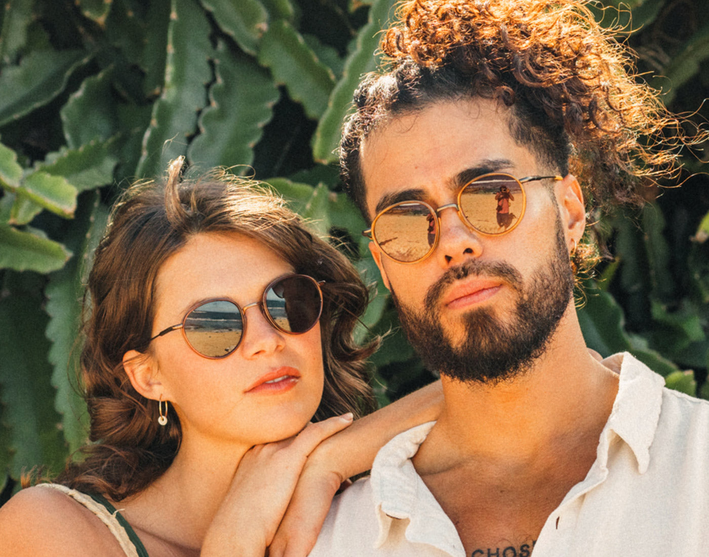 man and woman looking seriously at the camera wearing sunski baia sunglasses