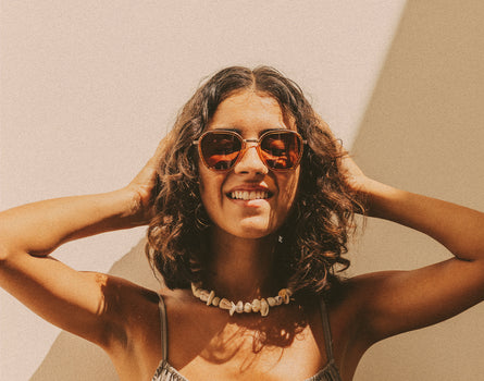 woman playing with her hair wearing sunski bernina sunglasses