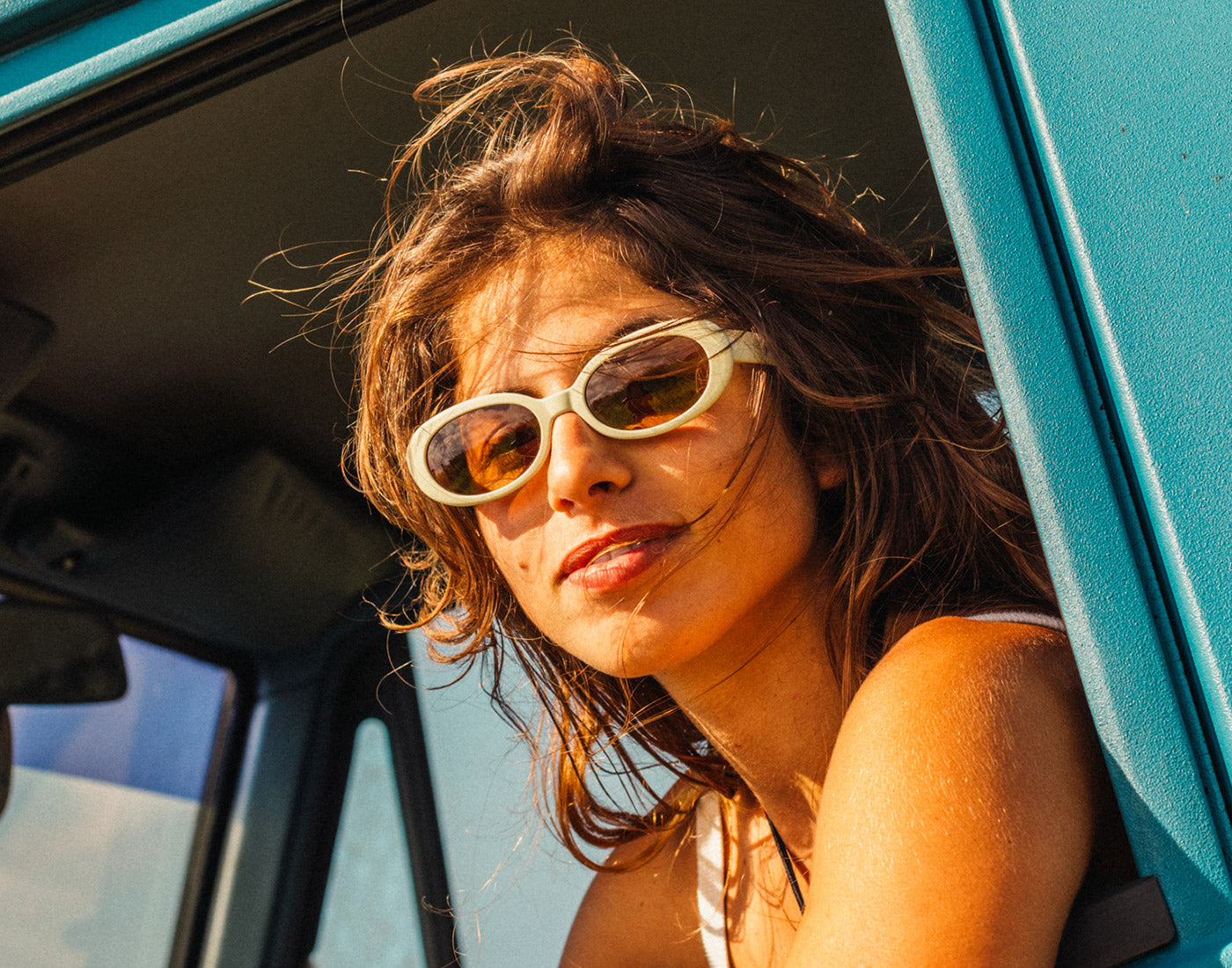 girl looking out car window wearing sunski bianca sunglasses