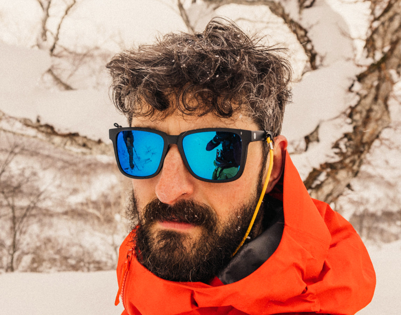 man looking at camera wearing sunski couloir sunglasses