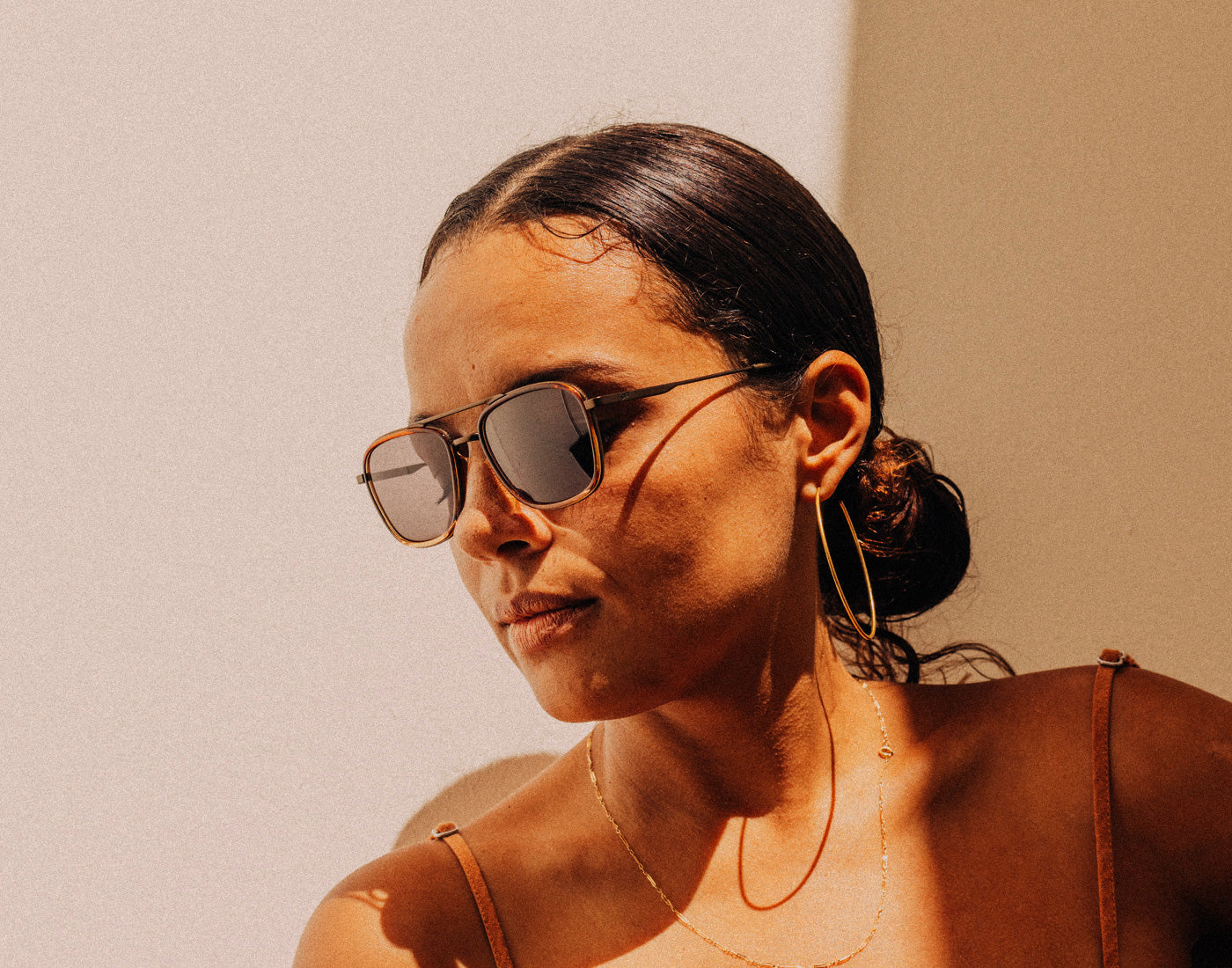 woman looking down wearing sunski estero sunglasses