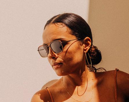 woman looking down wearing sunski estero sunglasses